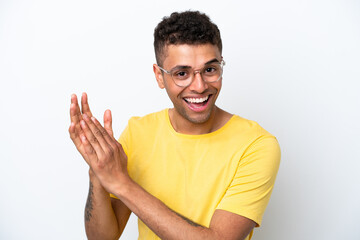 Wall Mural - Young Brazilian man isolated on white background With glasses and applauding