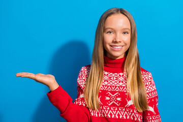 Sticker - Photo of nice girlish schoolgirl with blond hair dressed red sweater palm presenting product empty space isolated on blue color background