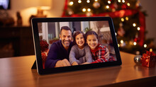 A Tablet Displaying A Smiling Person With Christmas Lights And Decorations In The Background, Symbolizing Holiday Cheer And Digital Connectivity.
