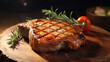 Grilled or pan fried pork chops on the bone, wood table background.