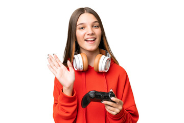 Poster - Teenager caucasian girl playing with a video game controller over isolated background saluting with hand with happy expression