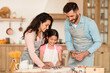 © Prostock-studio - Family baking together in a cozy kitchen