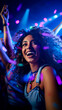 Girl dancing in a club, a disco or at a rave. Smiling looking happy while partying the night away on the dancefloor with colorful lights and confetti. Shallow field of view.