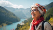 © Nataliya - Portrait of a senior woman wearing sunglasses looking away and arms crossed with a smile while standing beside the lake with mountains background. Aged people, journey and holiday concept.