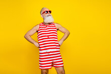 Photo Of Cheerful Dreamy Senior Man Wear Red Striped Swimsuit Looking Empty Space Isolated Yellow Color Background