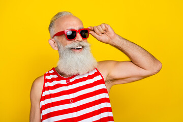 Sticker - Photo of funny cheerful senior man wear red striped swimsuit dark glasses looking empty space isolated yellow color background