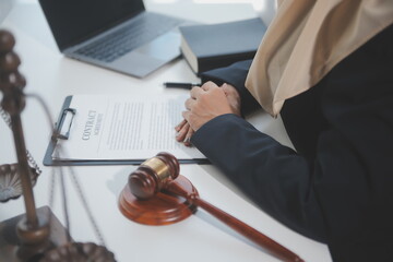 Business and lawyers discussing contract papers with brass scale on desk in office. Law, legal services, advice, justice and law concept picture with film grain effect