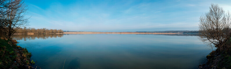 Wall Mural - Panorama lake view in sunrise time .Sunrise at the lake