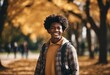 Portrait of a smiling young black student on colledge campus in the fall ready to start school year