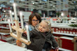 © Anna - Teenager boy with little toddler girl looking at Christmas decorations in a large supermarket. Children waiting for New Year, preparation for winter holidays. High quality photo