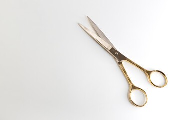 golden scissors on a white background. beauty, fashion, haircut, style concept.