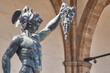 Bronze statue of Perseus with the head of Medusa, masterpiece by Benvenuto Cellini in Florence, Loggia dei Lanzi in the background in Florence