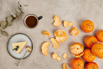 Wall Mural - ripe tangerines and traditional hot chocolate drink and Christmas pudding on grey textured surface