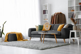 Fototapeta Panele - Interior of living room with black sofa and clothes rack