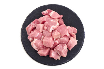 Wall Mural - Raw pork pieces on stone plate, close-up, isolated on white background.