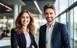 © piai - Smiling businessman and businesswoman in a modern bright office