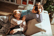 © Marko Geber - Couple of gay woman relaxing on the couch at home