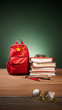 Backpack with a Chinese flag, a stack of books and glasses. The concept of learning Chinese. Asian languages courses, education and work in China, Hong Kong, Taiwan and Macau. Vertical 9:16 image.