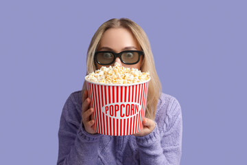 Poster - Young woman in 3D glasses with bucket of popcorn on purple background