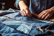 woman's hand sews a piece of blue fabric. Close-up upcycled denim and sustainable fashion, eco-conscious practices and nature-friendly materials for an responsible and eco-conscious lifestyle.
