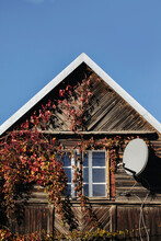 Wooden Window Rustic Cottage House. Vintage Wall With Transparent Glass Window. Countryside Architecture Historic Building. Direction Tv Antenna On Rooftop. Autumn Ivy Leaves. Creeper Plant House.
