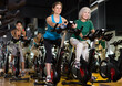 © JackF - Portrait of middle-aged and elderly women exercising together during stationary bike workout in fitness center
