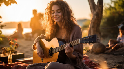 Adult girl plays guitar in park at sunset, young woman guitarist practices music at picnic. Female player with acoustic instrument outside home in summer. Concept of nature, musician, people