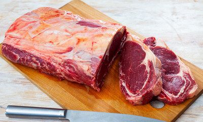 Wall Mural - Closeup of beef tenderloin on wooden cutting board