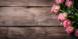 Fototapeta Kwiaty - Pink roses on wooden table as background, space for text