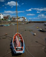 Vertical Shot Of A  Boat Beached During Low Tide In Bridlington Harbor.