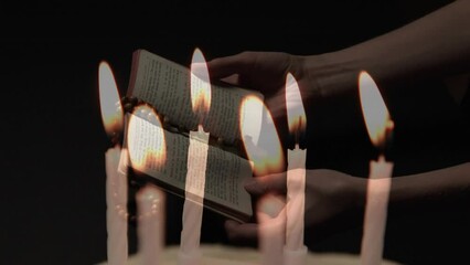 Canvas Print - Composite video of burning candles against woman hands holding bible and rosary praying