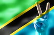 Tanzania - two fingers showing peace sign and national flag
