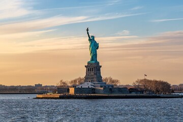 Wall Mural - Breathtaking image of the iconic Statue of Liberty in New York City, USA under a stunning sunset sky