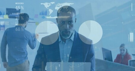 Wall Mural - Animation of infographic interface over african american mature businessman in suit using laptop