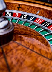 Vertical closeup of a roulette wheel in a casino