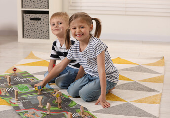 Sticker - Little children playing with set of wooden road signs and toy cars indoors