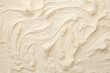 © Surachetsh - Close up detail of milk vanilla white creamy ice cream surface and texture is swirled and mixed, abstract background and wallpaper. Generative AI.