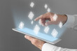 © New Africa - Marketing strategy. Man using tablet computer on grey background, closeup. Different icons above device screen