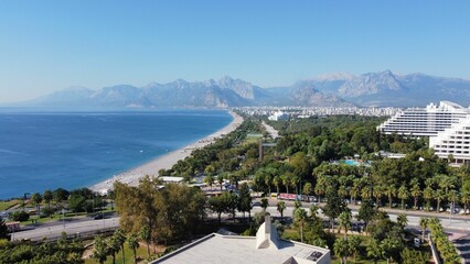 Sticker - View of a bustling Antalya cityscape featuring an array of tall buildings and trees