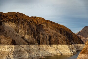 Wall Mural - Scenic landscape shot of a mountain range in the distance, with a bright blue sky overhead