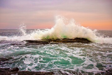 Sticker - Beautiful view of a shoreline with rock formations and crashing sea waves