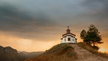 Small Orthodox Christian Chapel On A Hill During A Beautiful Sunset