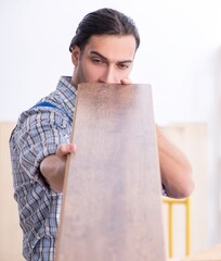 Wall Mural - Young male carpenter working indoors