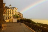 Fototapeta Tęcza - there is a rainbow in the sky over a colorful building: Vasto, Abruzzo, Italy