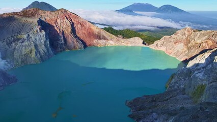 Wall Mural - Aerial view Drone shot of fog at Kawah Ijen volcano with turquoise sulfur water lake and sunrise light.Amazing nature landscape view at East Java,Indonesia.Beautiful light Natural landscape background