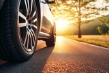 Fototapeta  - Summer tires on an asphalt road under the sun