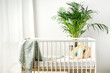 White wooden baby crib in nursery room