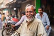 Portrait of a smiling old man sitting in the street, India