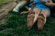 Countryside barefoot kid with dirty feet, enjoying the hug of her family