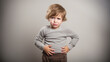 sad little boy holding his stomach, illness, cramps, health, color background, stomach-ache, abdominal, griping, bellyache, tummy-ache, gripes, portrait, ill, child, kid, baby, toddler, son, cry